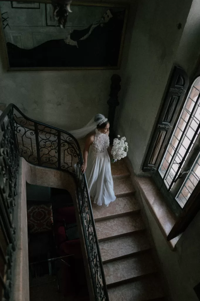 Ellie walking down the stairs before her chateau de la napoule wedding