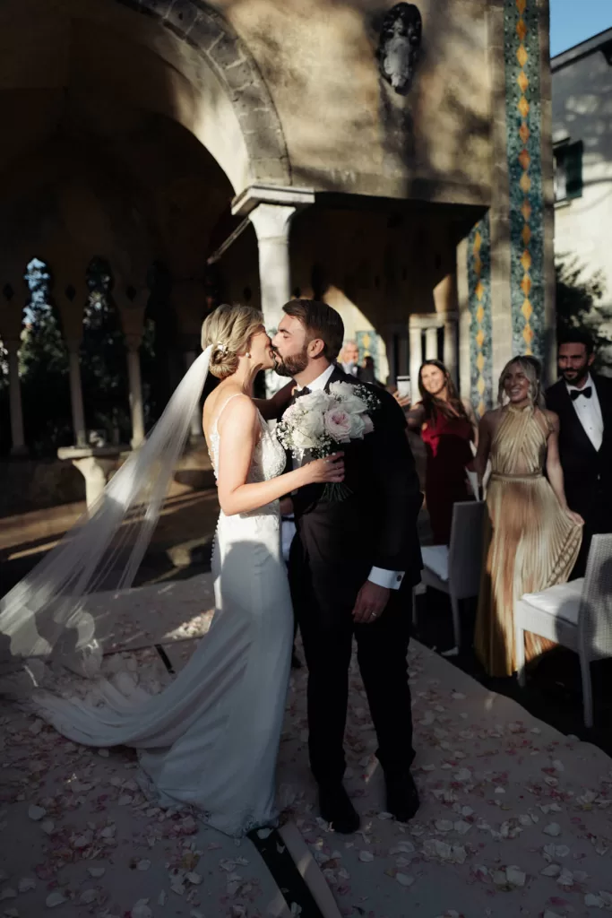 A couple embrace mid-ceremony at their Villa Cimbrone wedding in Ravello